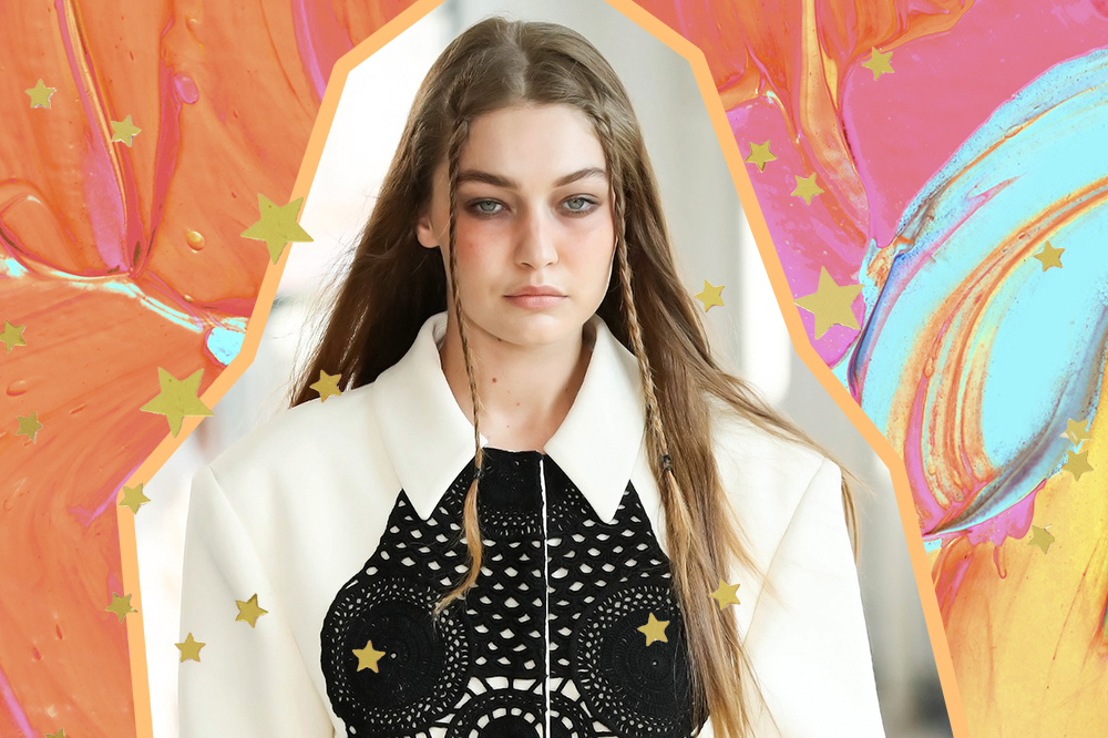 Gigi Hadid no desfile de primavera-verão 2022 da Altuzarra na semana de moda de Nova York. Ela está com expressão facial séria, trancinhas na franja, camisa branca e detalhe preto no decote. A montagem tem fundo colorido em tons de tintas laranjas e azuis, além de estrelinhas douradas.