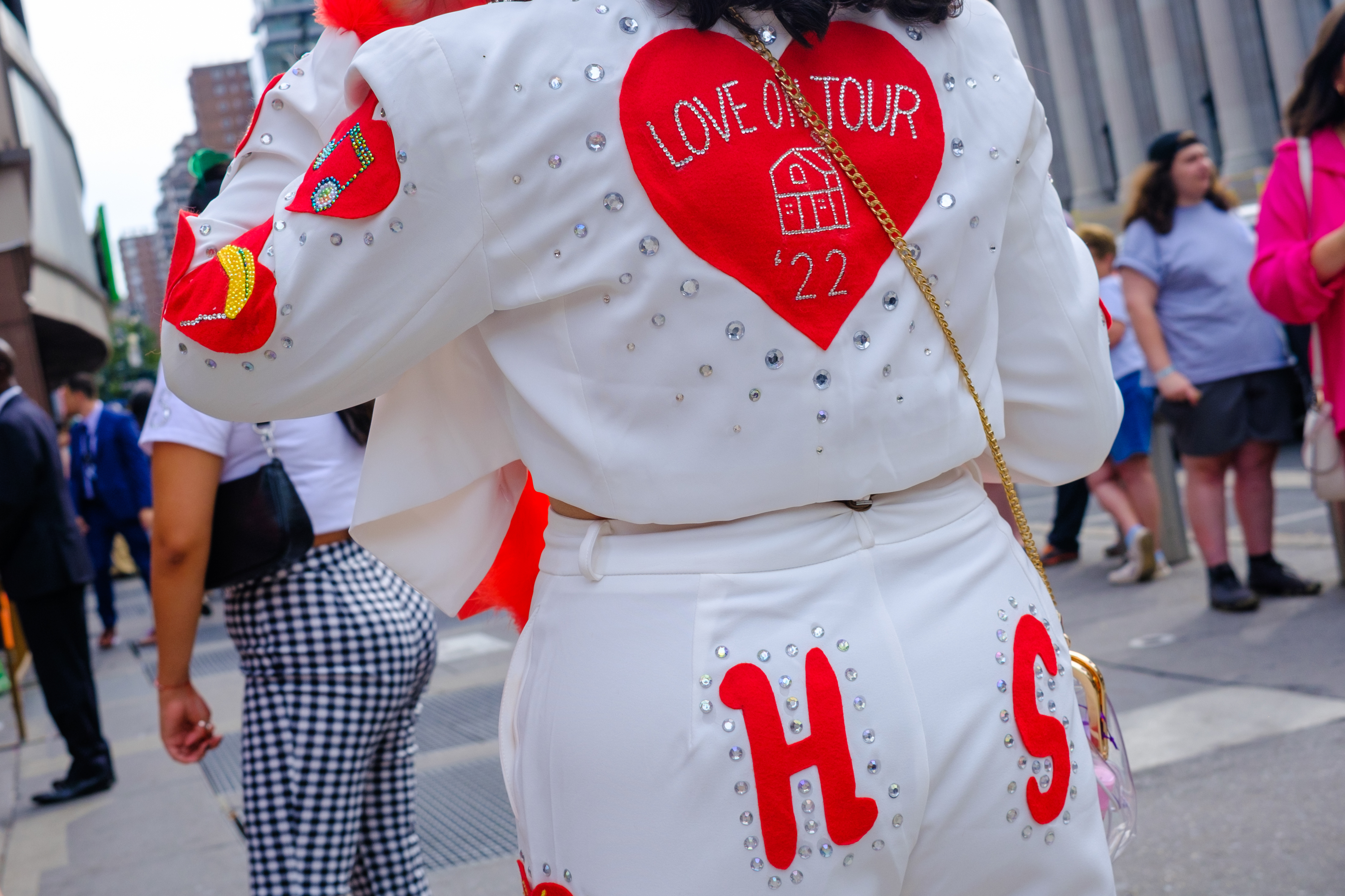 Fans Arrive For Harry Styles Concert In New York City Look branco e vermelho de fã na Love On Tour, do Harry Styles, em Nova York