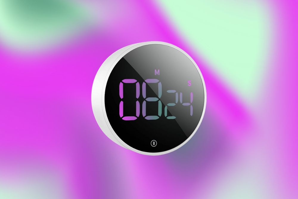 Método 'Pomodoro' pode transformar seus estudos Imagem de um temporizador branco em um fundo roxo e verde.