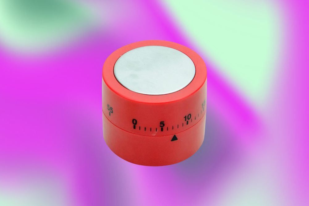 Imagem de um temporizador vermelho em um fundo roxo e verde.