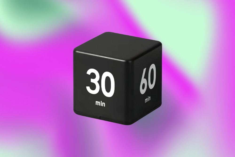 Método 'Pomodoro' pode transformar seus estudos Imagem de um temporizador preto em um fundo roxo e verde.